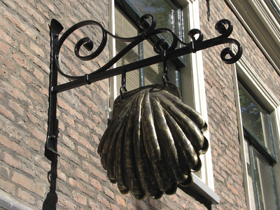 906035 Afbeelding van een bronzen jacobsschelp, uitgehangen bij het Huis van Sint Jacob (Janskerkhof 28a) te Utrecht.
